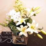 Artificial White Lilies, White Hydrangea, and Pale Green Lilac in Square Vase