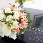Artificial (soft-touch) white calla lilies, cream roses, pink eremurus, and ivory snow berries bridal bouquet