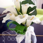 Artificial white calla lilies bridesmaid bouquet, with monstera and aspidistra leafs and tied in white satin bow