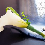 Artificial white calla lily boutonniere with boxwood leafs, lily grass, and double pearl pins (side-view)
