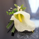 Artificial (soft-touch) white calla lily boutonniere with lily grass, boxwood leafs, ivory snow berries, and double pearl pins (top-view)