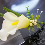 Artificial (soft-touch) white calla lily boutonniere with lily grass, boxwood leafs, ivory snow berries, and double pearl pins (side-view)