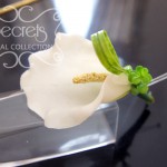 Artificial white calla lily boutonniere with boxwood leafs, lily grass, and double pearl pins (top-view)