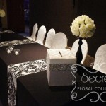 Receiving Table is Decorated with Ivory Rose Ball Arrangements, Bling! Bling! Money Box, and Small Bling! Bling! Candles