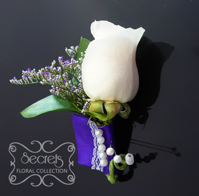 Fresh cream rose and purple limonium boutonniere, with purple wrap and embellished with lace and pearls (front-view) - Toronto Wedding Flowers Created by Secrets Floral Collection
