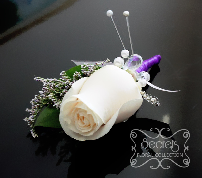 Fresh cream rose and purple limonium boutonniere, with purple and silver ribbon wrap and jewel embellishments - Toronto Wedding Flowers Created by Secrets Floral Collection