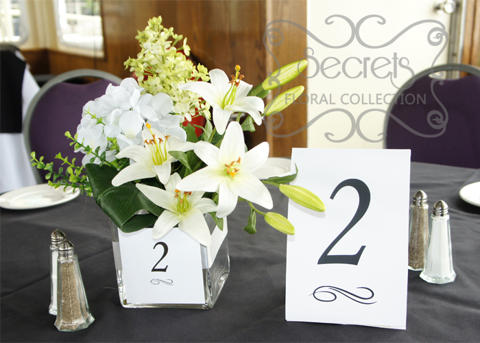 Artificial White Lilies, White Hydrangea, and Pale Green Lilac in Square Vase with Table Number