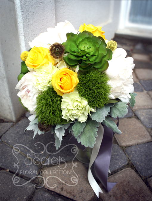 Fresh white peonies, yellow roses, green trick dianthus, succulents, light green carnations, cream hydrangea, scabiosa pods, craspedia Billy balls, and dusty bridal bouquet, with silver ribbon wrap (front-view) - Toronto Wedding Flowers by Secrets Floral Collection