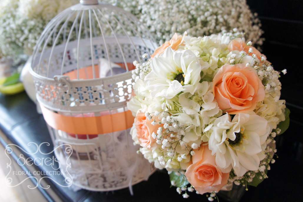 Fresh peach roses, white dahlia, cream hydrangea, and baby's breath bridal bouquet, with ivory multi-loops wrap, black jewel, and sentimental photo frames (top-view) - Toronto Wedding Flowers by Secrets Floral Collection