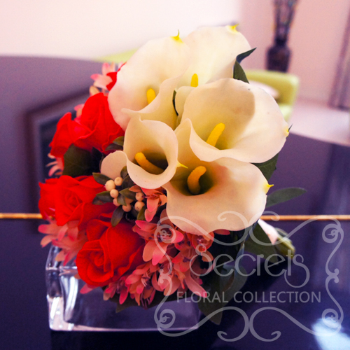 Artificial (soft-touch) white calla lilies, Charlotte red roses, pink agapanthus, and ivory snow berries bridal bouquet (side-view) - Toronto Wedding Flowers by Secrets Floral Collection