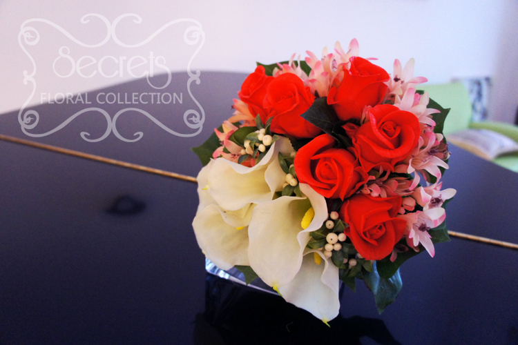 Artificial (soft-touch) white calla lilies, Charlotte red roses, pink agapanthus, and ivory snow berries bridal bouquet (top-view) - Toronto Wedding Flowers by Secrets Floral Collection