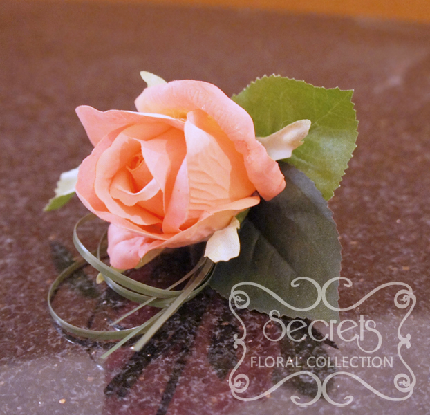 Artificial coral pink rose and and bear grass boutonniere (Top View) - Toronto Wedding Flowers Created by Secrets Floral Collection