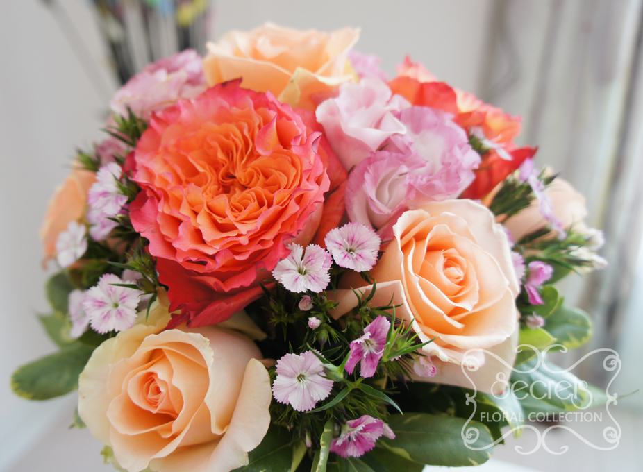 Fresh two-tone peach garden roses (free spirit), peach standard roses, bi-colour pink lisianthus, and light pink sweet william bridesmaid bouquet, with salmon pink wrap (close-up) - Toronto Wedding Flowers Created by Secrets Floral Collection