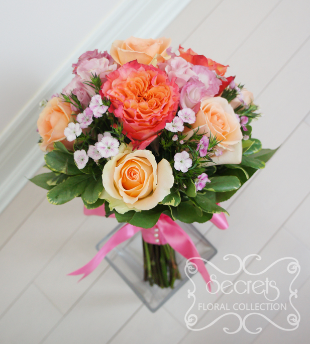 Fresh two-tone peach garden roses (free spirit), peach standard roses, bi-colour pink lisianthus, and light pink sweet william bridesmaid bouquet, with salmon pink wrap (front-view) - Toronto Wedding Flowers Created by Secrets Floral Collection
