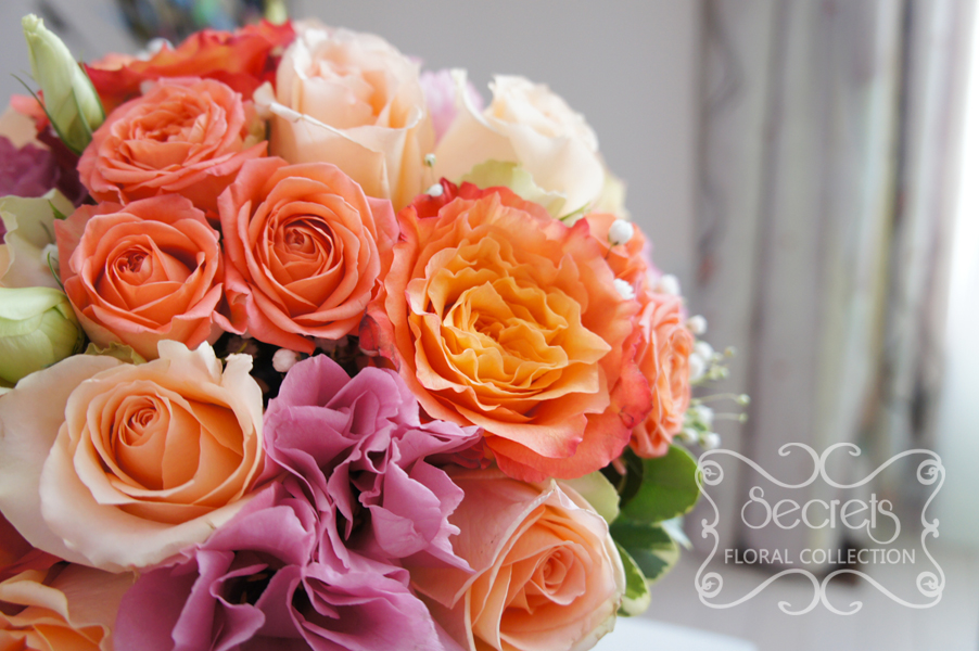 Fresh two-tone peach garden roses (free-spirit), peach standard and spray roses, solid pink and bi-colour pink lisianthus, and baby's breath bridal bouquet, with coral pink ribbon wrap (close-up) - Toronto Wedding Flowers by Secrets Floral Collection