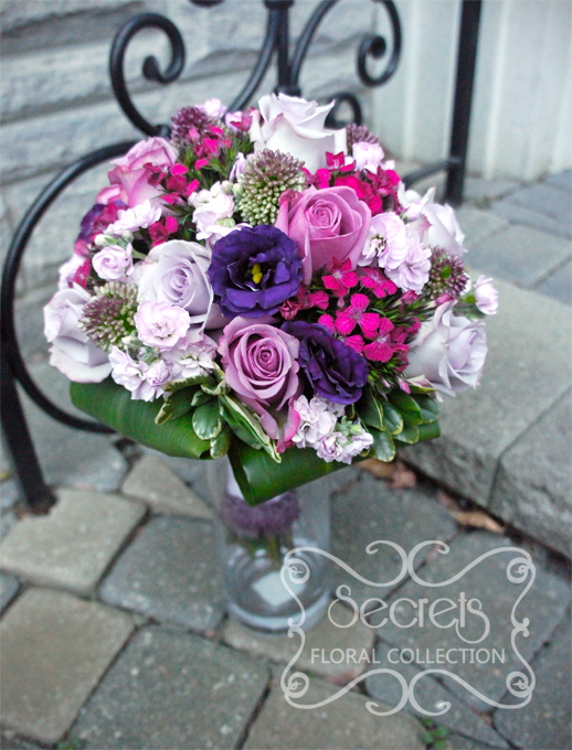 Fresh purple lisianthus, lavender roses, purple bullet alliums, lavender stock fowers, and fuchsia sweet william bridal bouquet, with lavender satin ribbon wrap and faux fur trim (top-view) - Toronto Wedding Flowers by Secrets Floral Collection