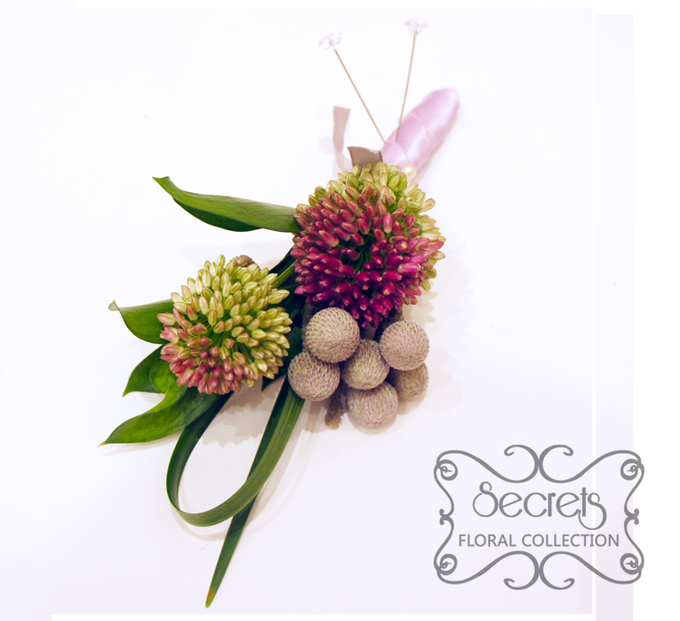 Fresh purple bullet alliums, silver brunia berries, and lily grass boutonniere, with silver and lavender ribbon (top-view) - Toronto Wedding Flowers Created by Secrets Floral Collection