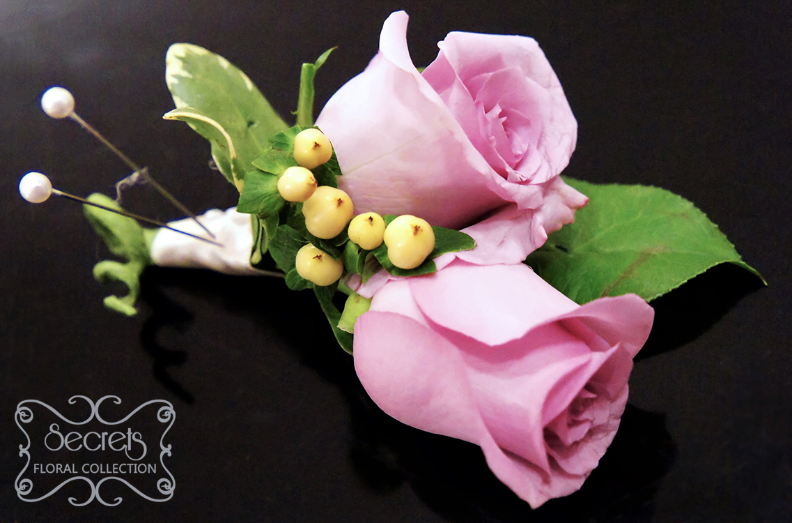 Double-bloom lavender roses and ivory hypericum berries boutonniere, with white satin wrap and curly tail - Toronto Wedding Flowers Created by Secrets Floral Collection
