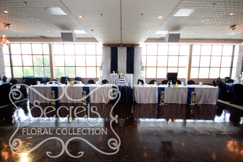 A Navy Blue and Silver Backdrop and Tables