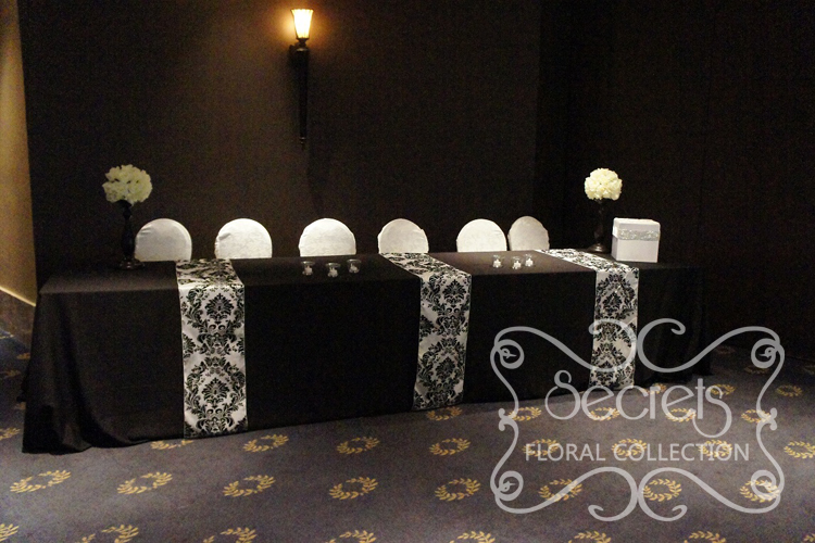 Black Receiving Table with Damask Runners and White Brocade Chair Covers