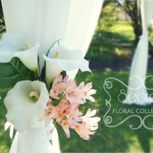 Close-up of the ceremony arch, with calla lilies arrangement