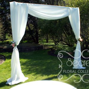 Our modern wedding arch, draped with soft white voile