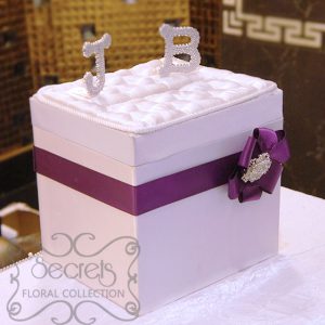 Our white satin money box, embellished with purple accent, and crystallized initials of the couple