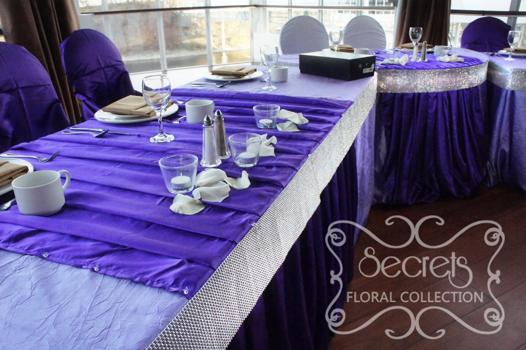Close up up head table, with pleated royal purple stripes