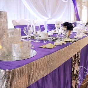 Close-up of the purple, damask, and crystallized head table - Toronto Wedding Decor Created by Secrets Floral Collection
