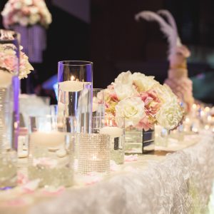 Wedding head and cake tables are filled with lots of crystals and candles, for an added touch of romance and ambience. Photo by Andes Lo Photography - Toronto Wedding Decor Created by Secrets Floral Collection