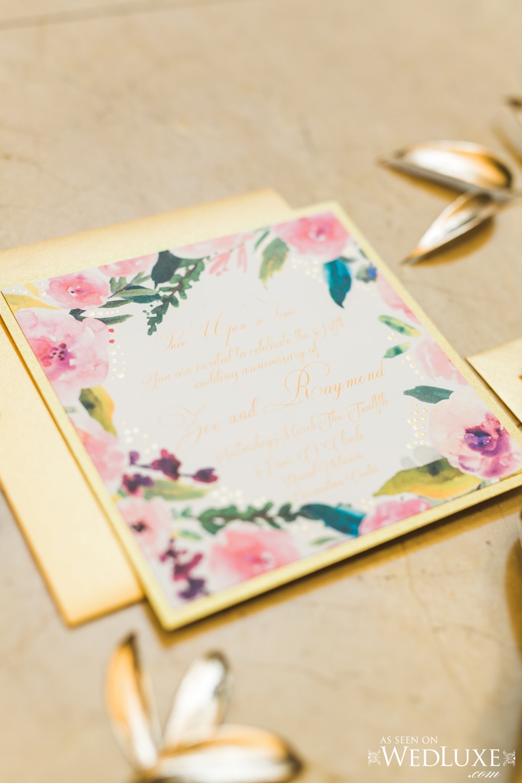 Detail shot of gold foliage and gold and floral themed wedding invitations. Cinderella themed style shoot located at the Victorian Convention centre, Missisauga.
