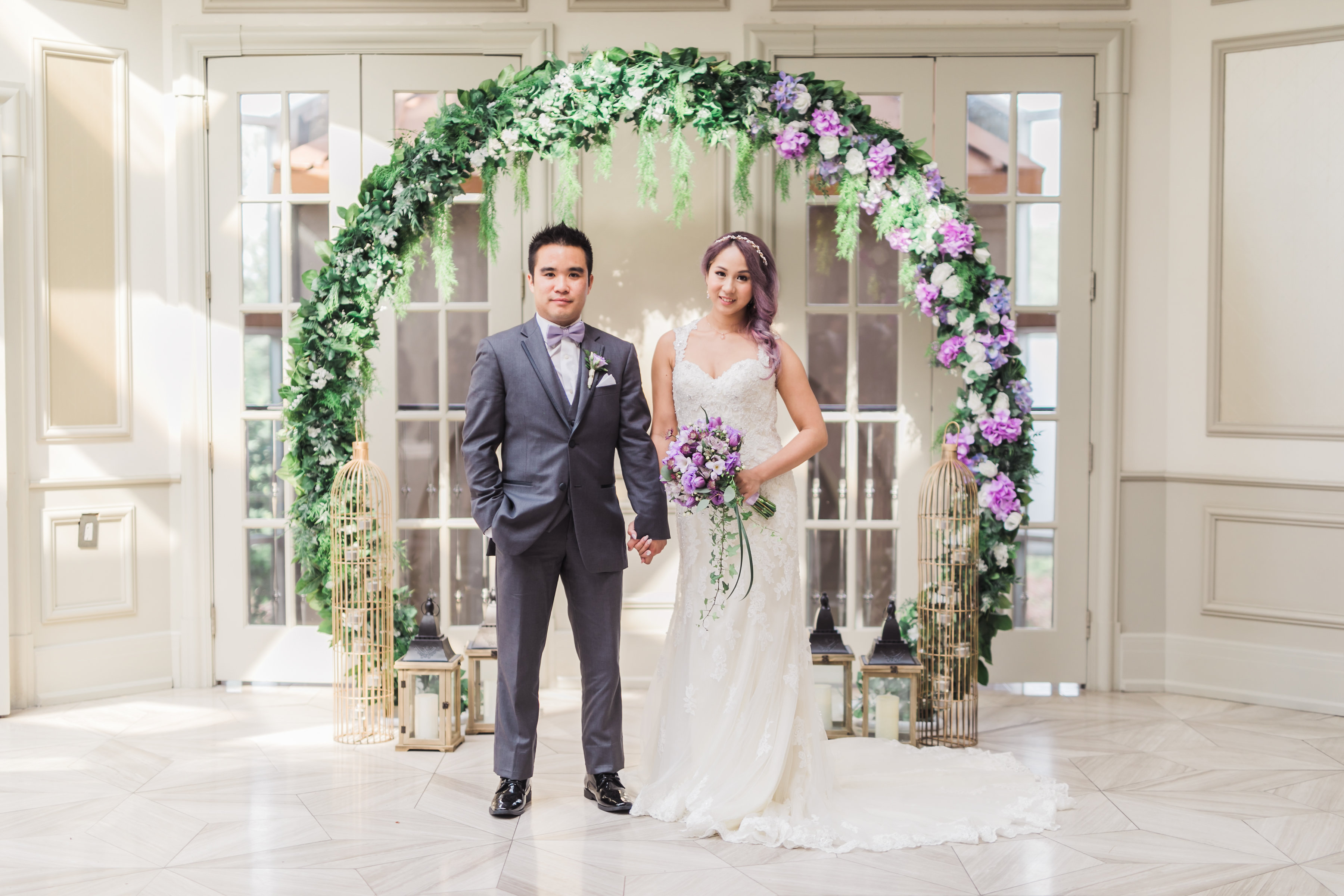 Wedding ceremony circular arch (Circle of Love), with cream and purple roses, hydrangea, and greenery. Toronto wedding flowers and decor at Fontana Primavera by Secrets Floral.
