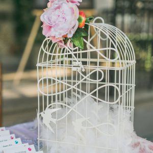 Rustic birdcage money box, embellished with pink peony flower. Toronto wedding decor at Graydon Hall by Secrets Floral.
