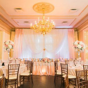 Wedding reception backdrop and head table in blush pink and gold. Toronto wedding decor at Graydon Hall by Secrets Floral.