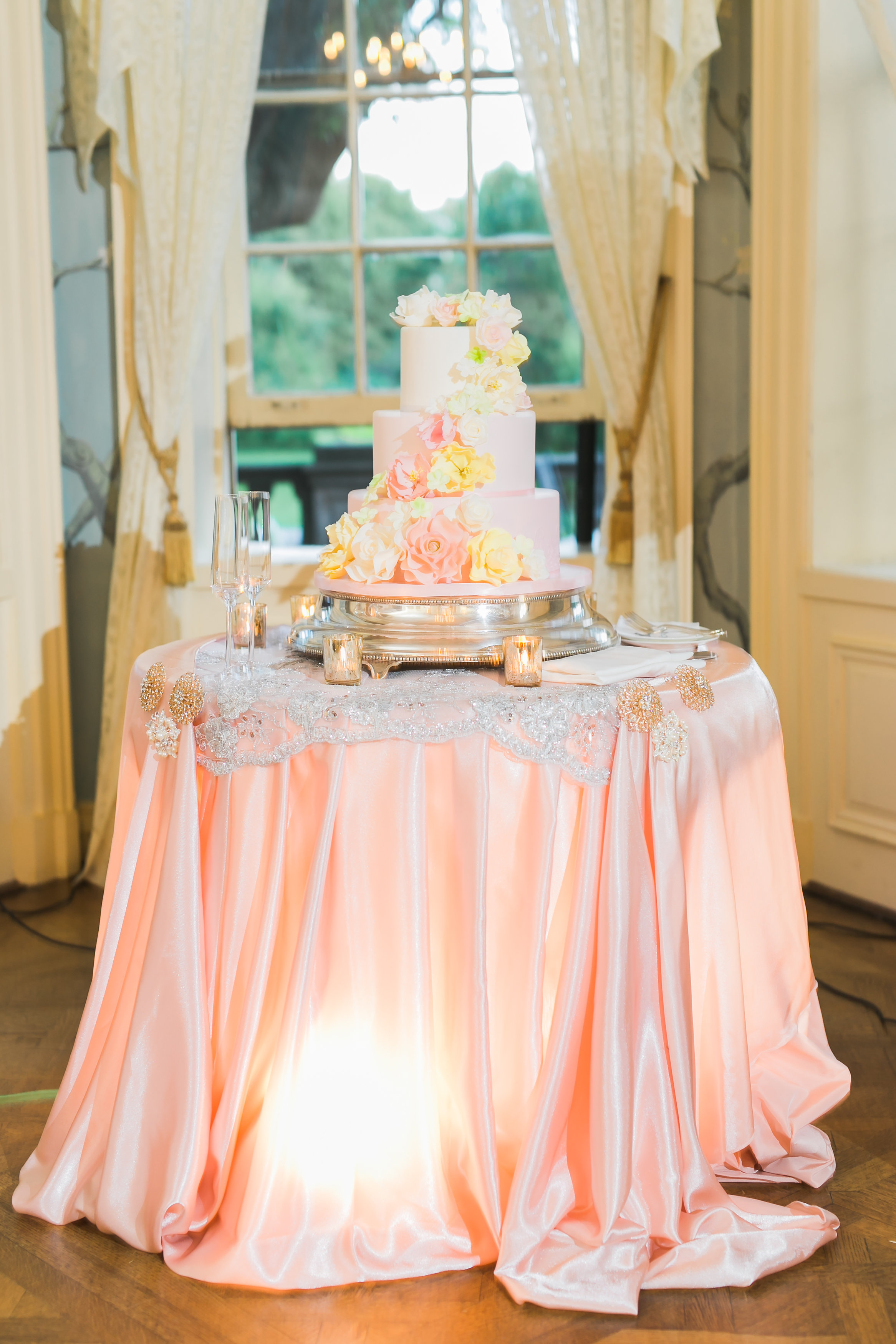 Wedding cake table in blush pink and gold. Toronto wedding decor at Graydon Hall by Secrets Floral.
